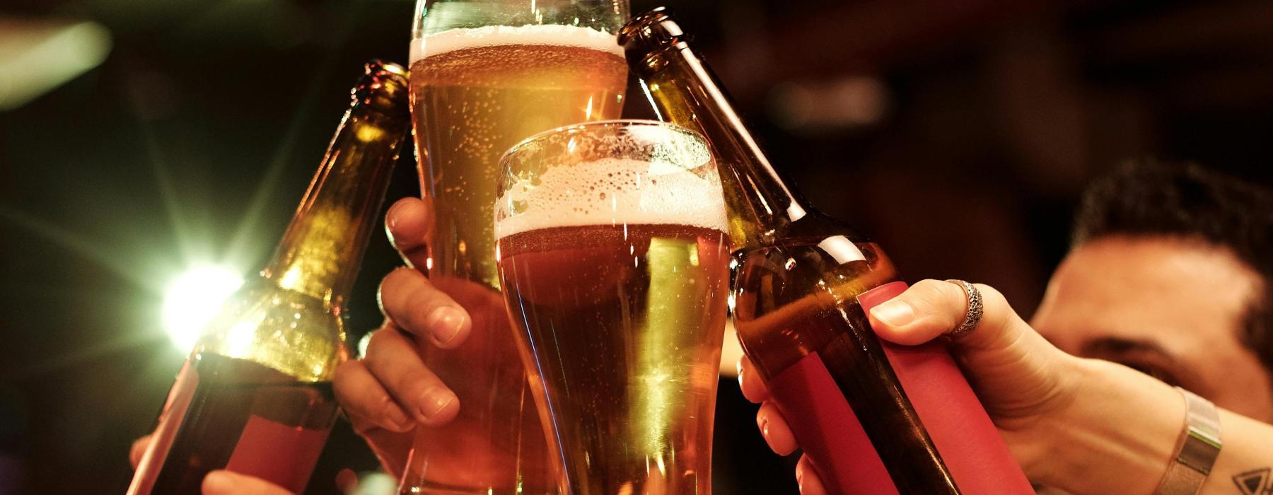 a group of people holding glasses of beer