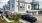 a black truck parked in front of a white house