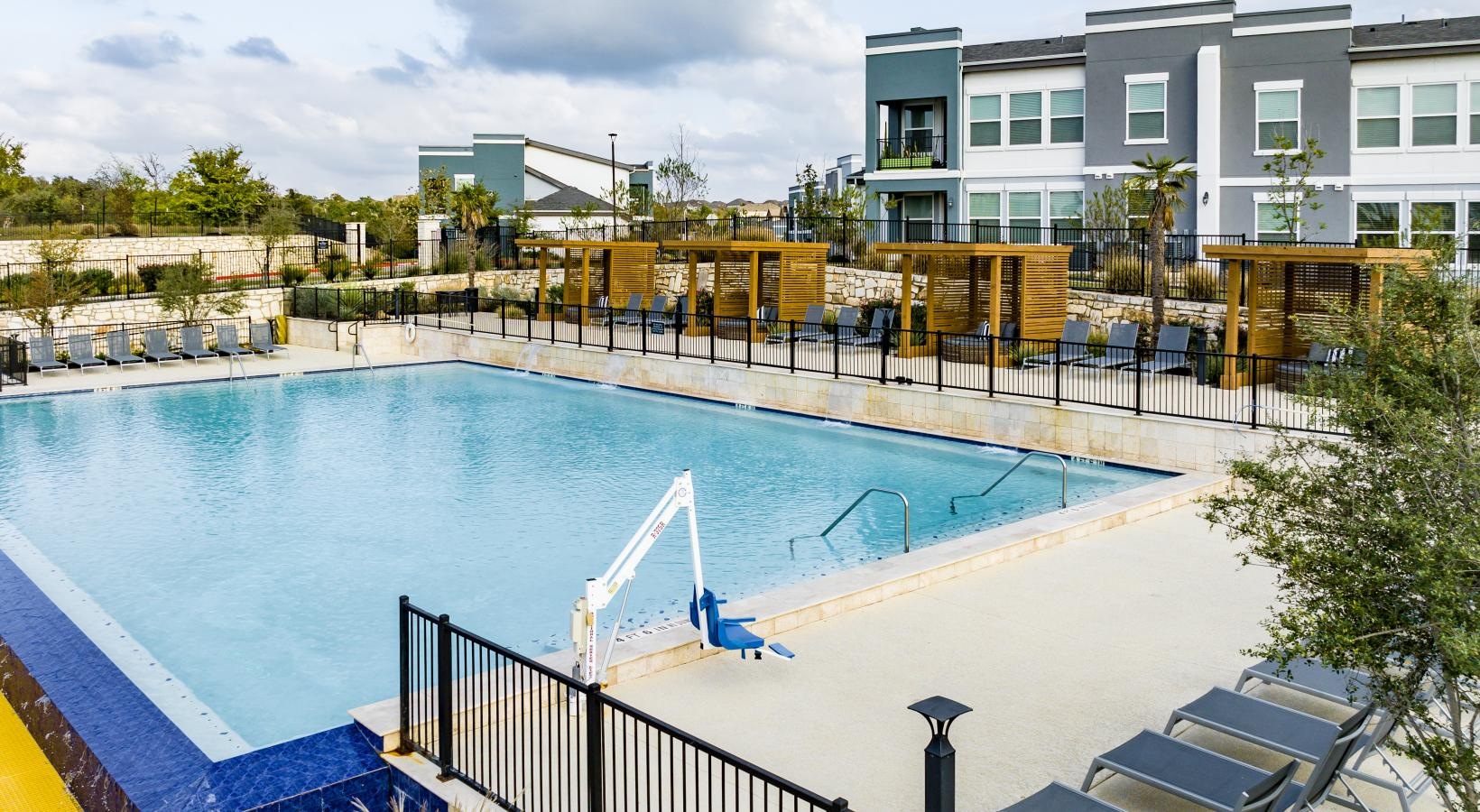 Settle into comfort at Reveal 54 a swimming pool with a fence around it