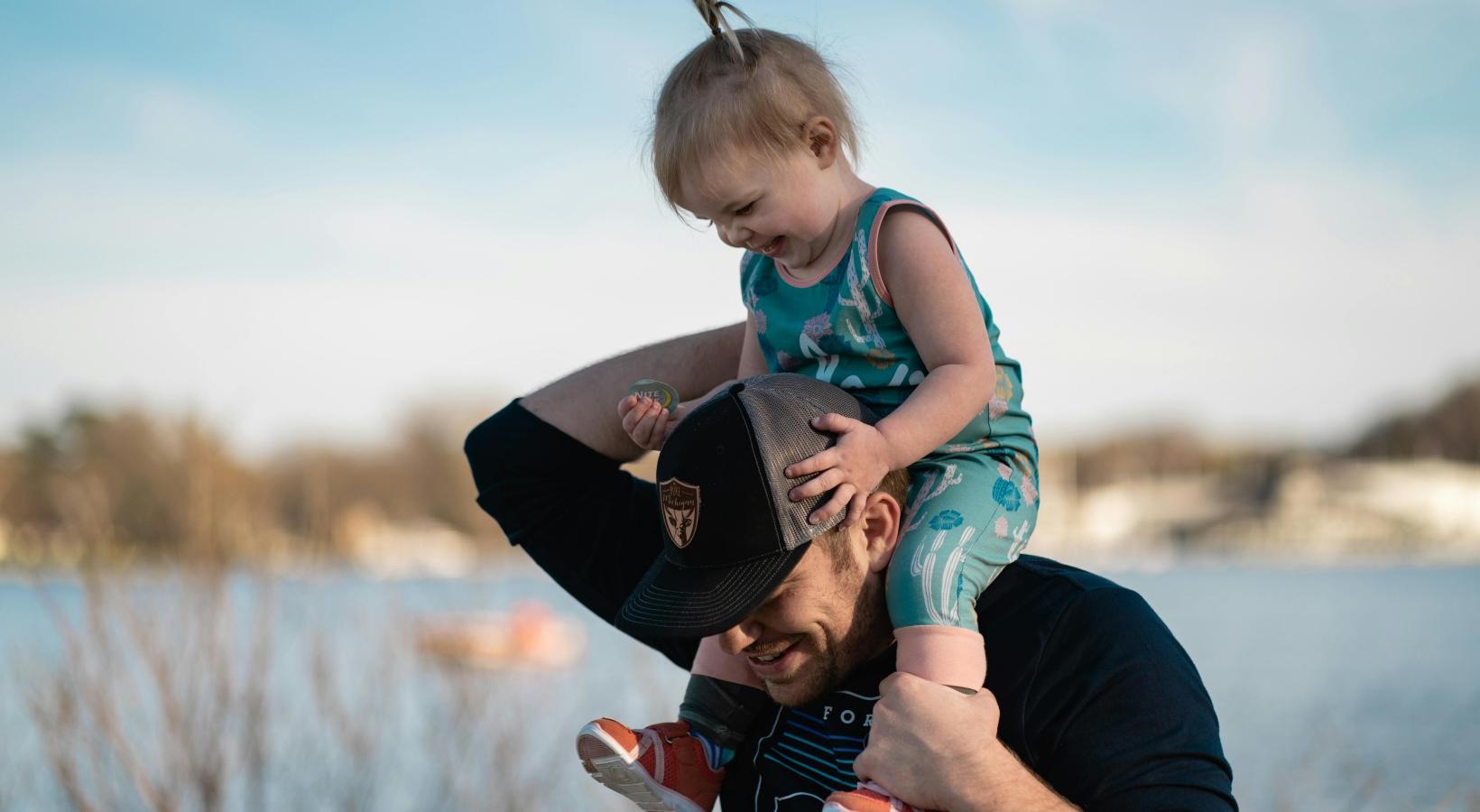 Find your perfect fit at Reveal 54 a person carrying a child on the shoulders
