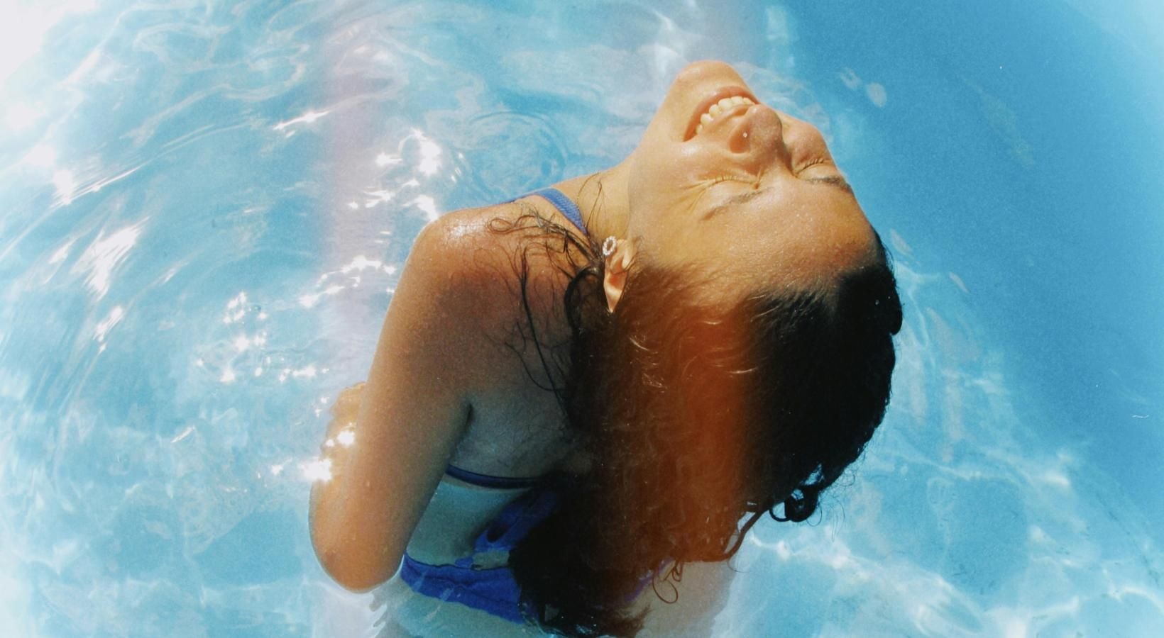 Resort-style swimming pool a person in a pool