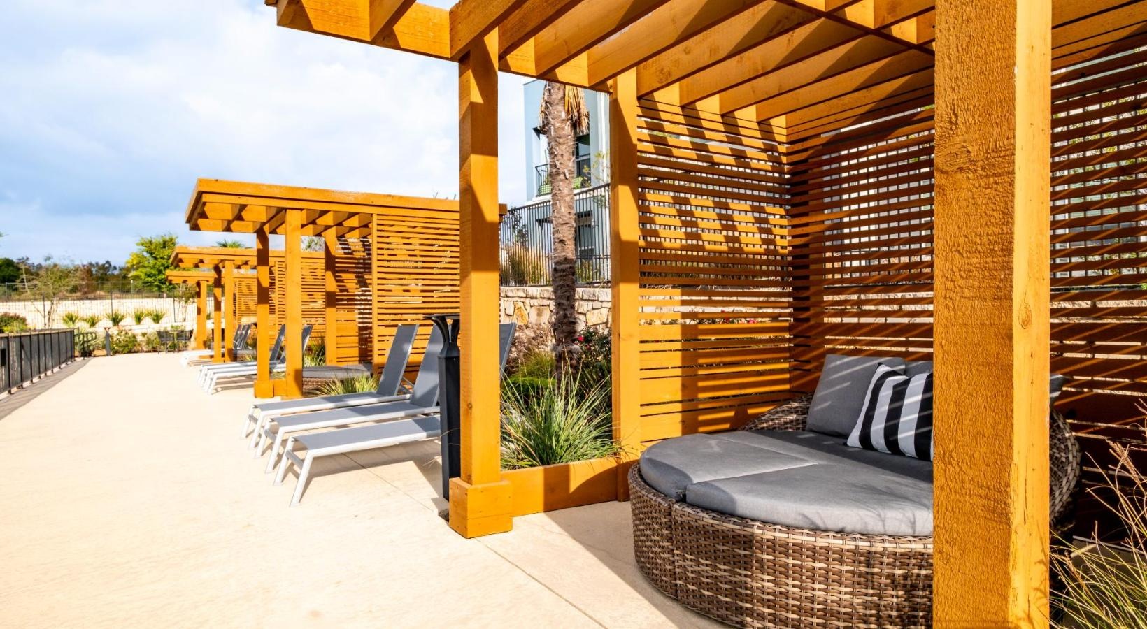 Settle into comfort at Reveal 54 a patio with a couch and a bench