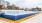 a swimming pool with a building in the background