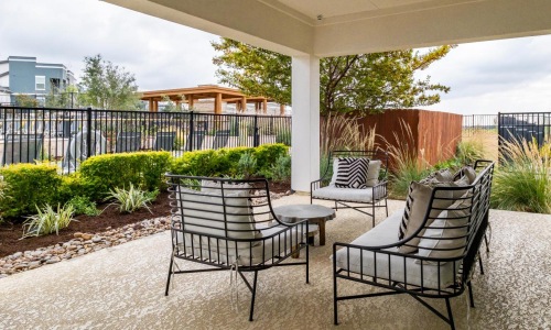 Find your perfect fit at Reveal 54 a patio with chairs and a table