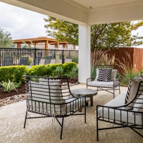 Find your perfect fit at Reveal 54 a patio with chairs and a table