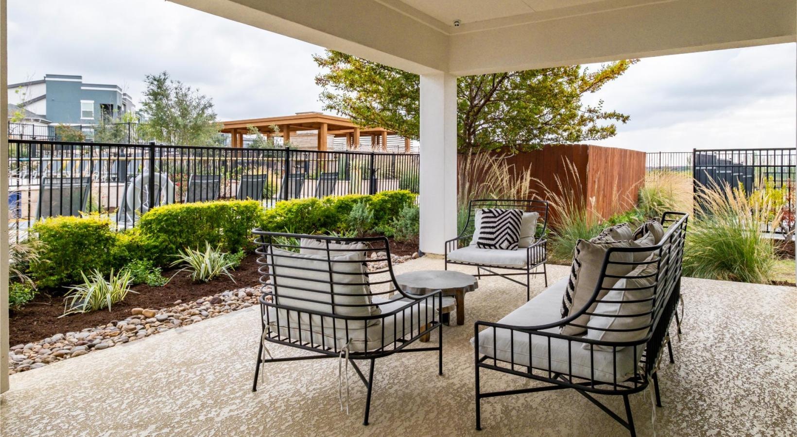 Find your perfect fit at Reveal 54 a patio with chairs and a table