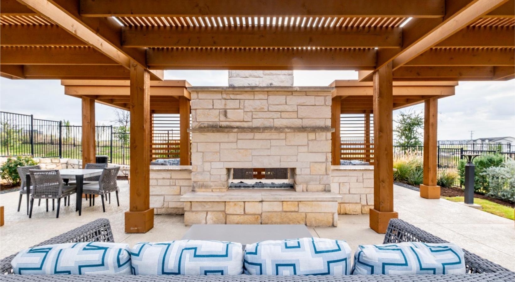 Find your perfect fit at Reveal 54 a patio with a fireplace and chairs