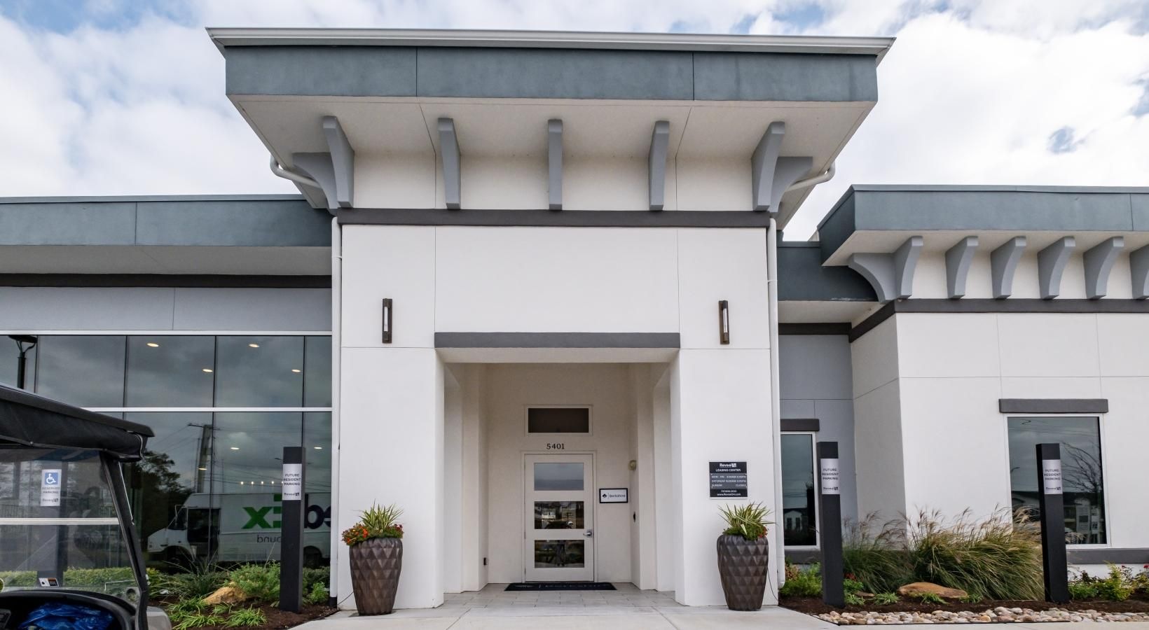 Find your perfect fit at Reveal 54 a building with a parking lot