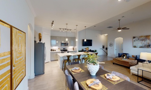 Wide open living areas flooded with natural light a large kitchen with a dining table