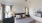 a bedroom with a bed and lamps