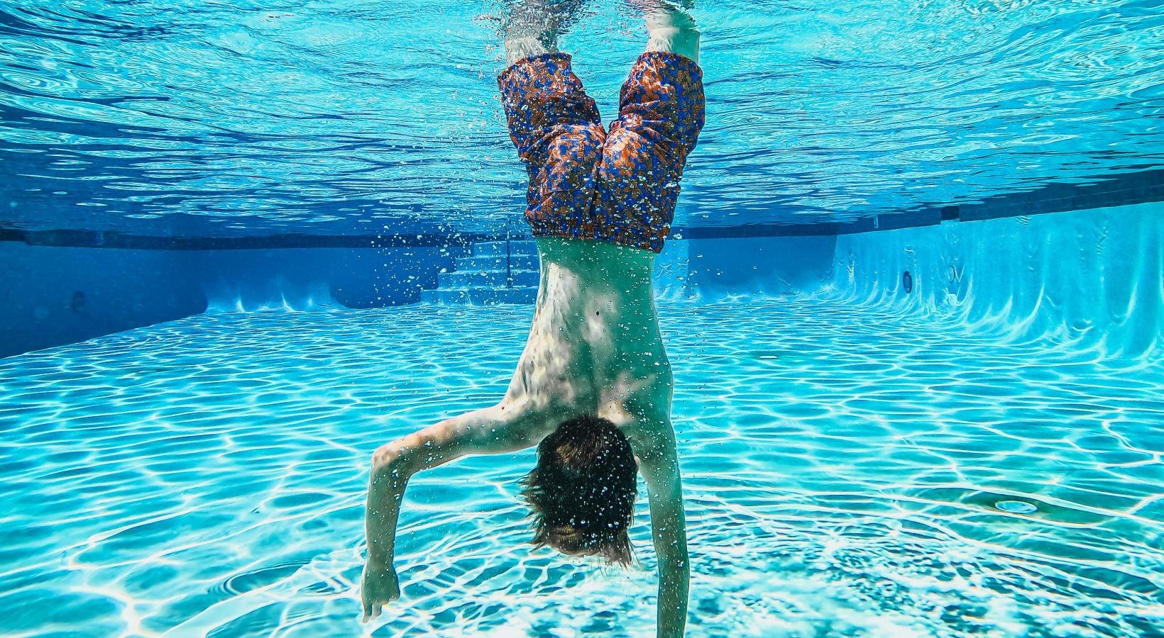 Shimmering resort-style pool a person in a pool