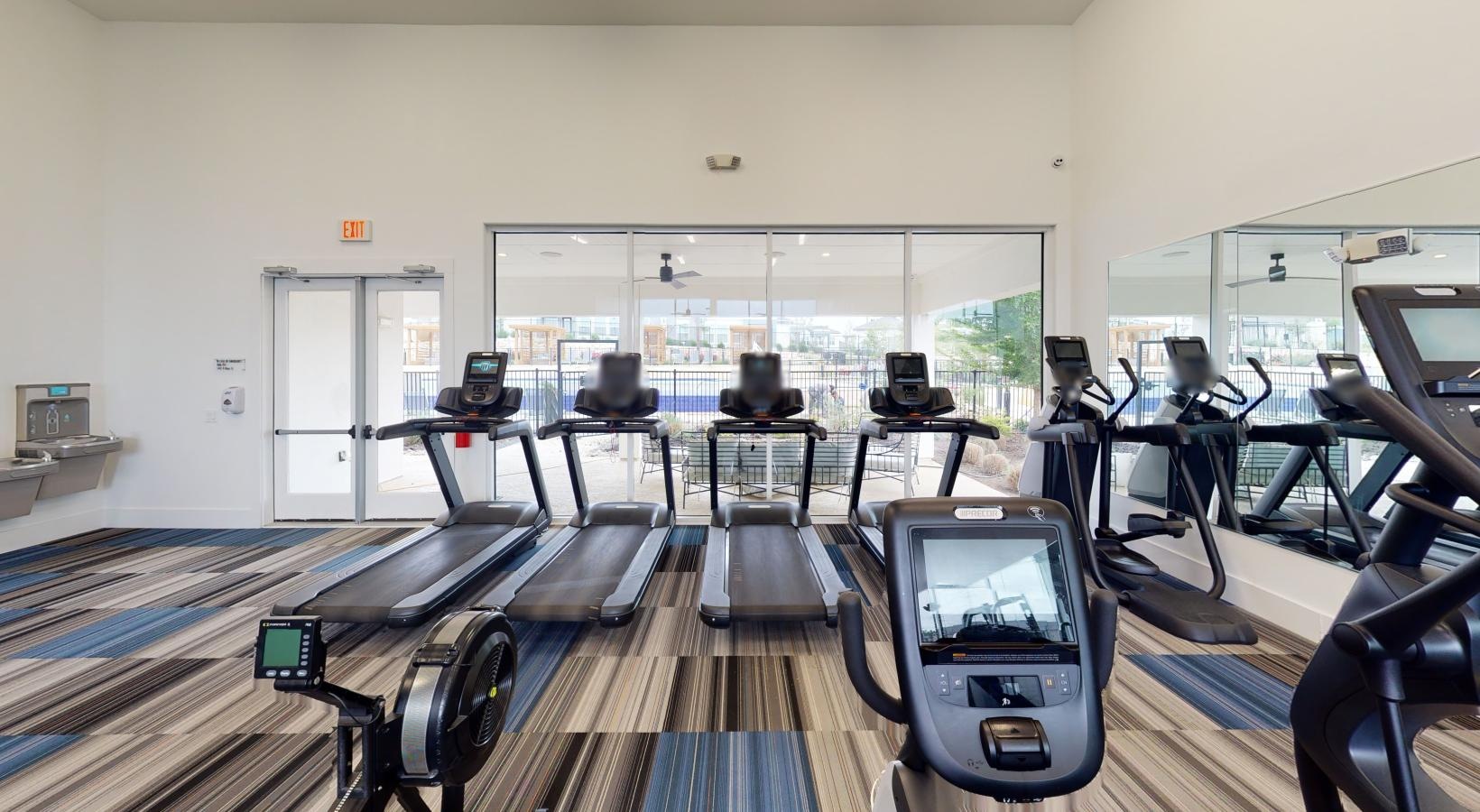 Find your perfect fit at Reveal 54 a room with exercise equipment and chairs