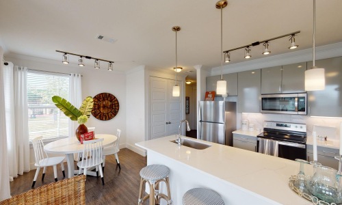 Gorgeous living areas to entertain and enjoy a kitchen with a dining table and chairs