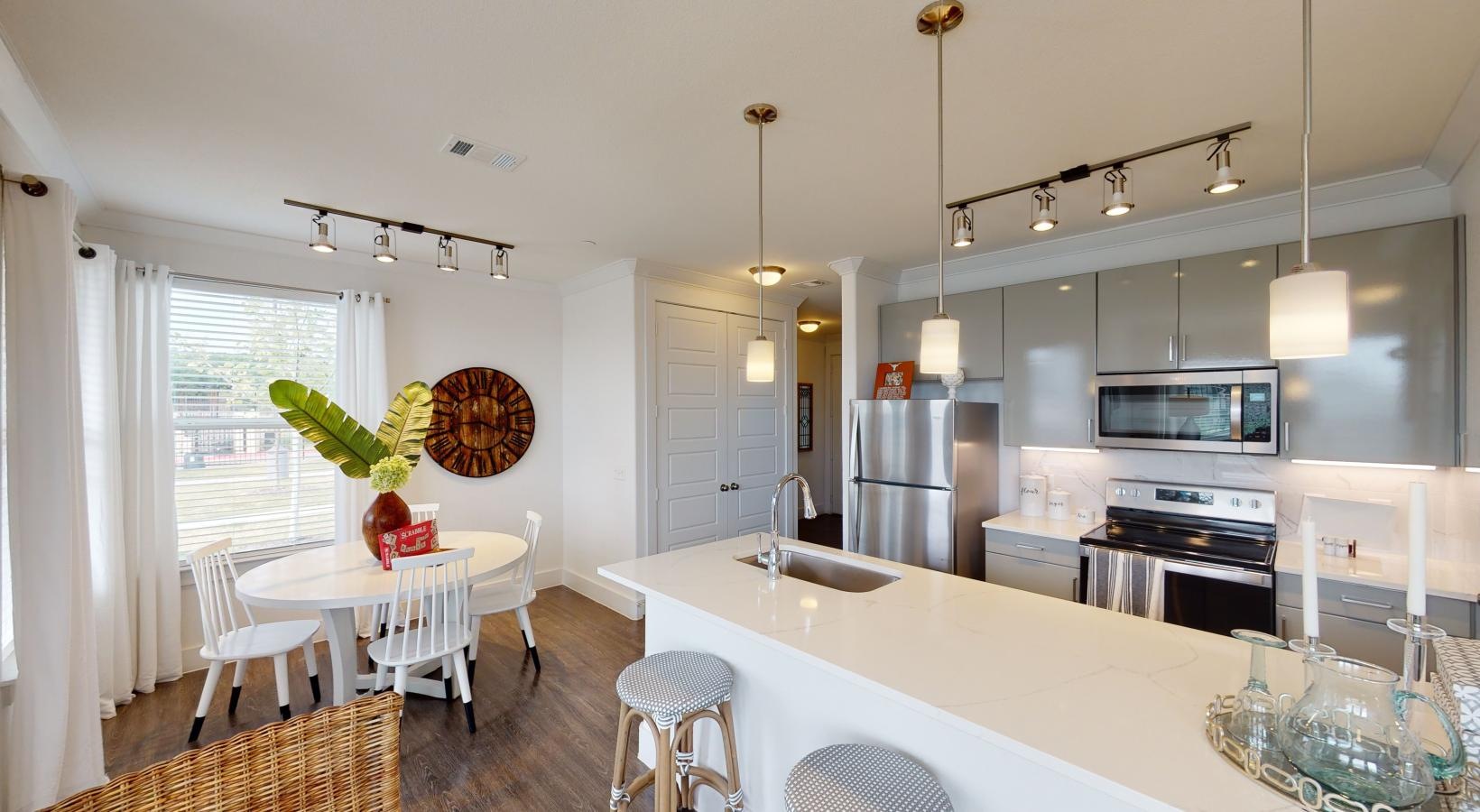 Gorgeous living areas to entertain and enjoy a kitchen with a dining table and chairs