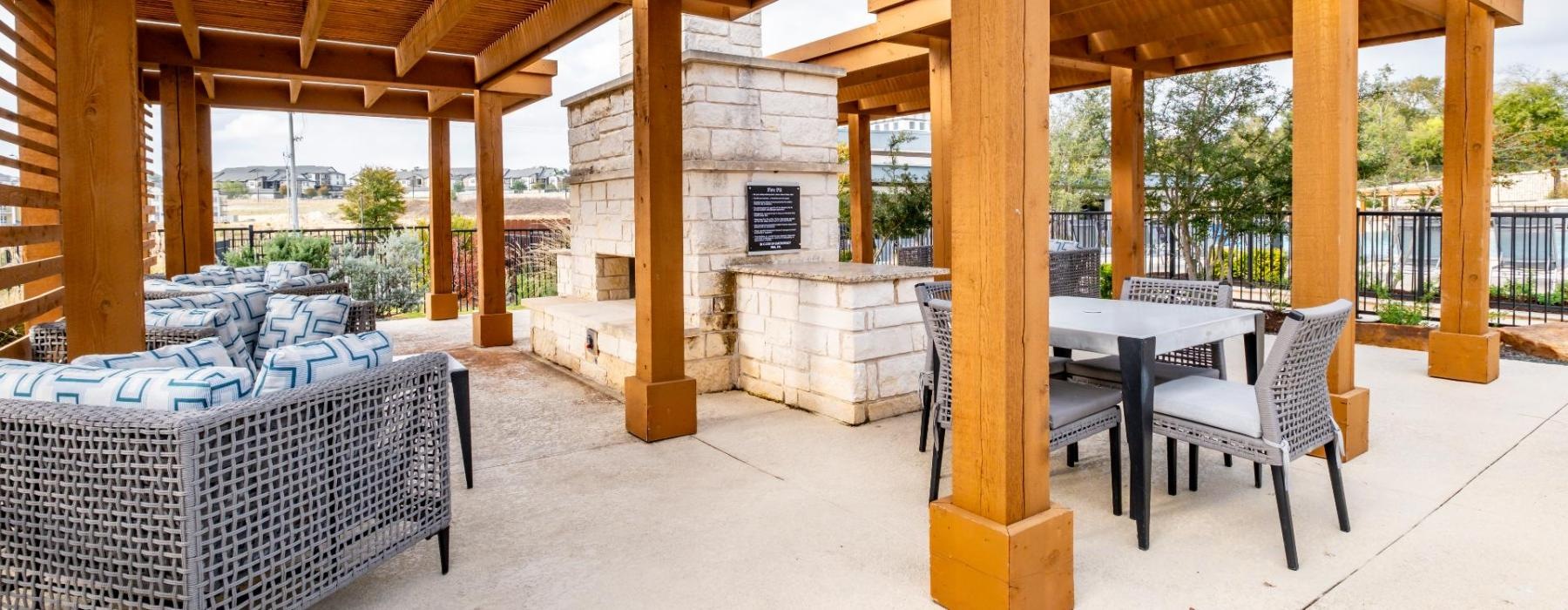 a patio with a table and chairs